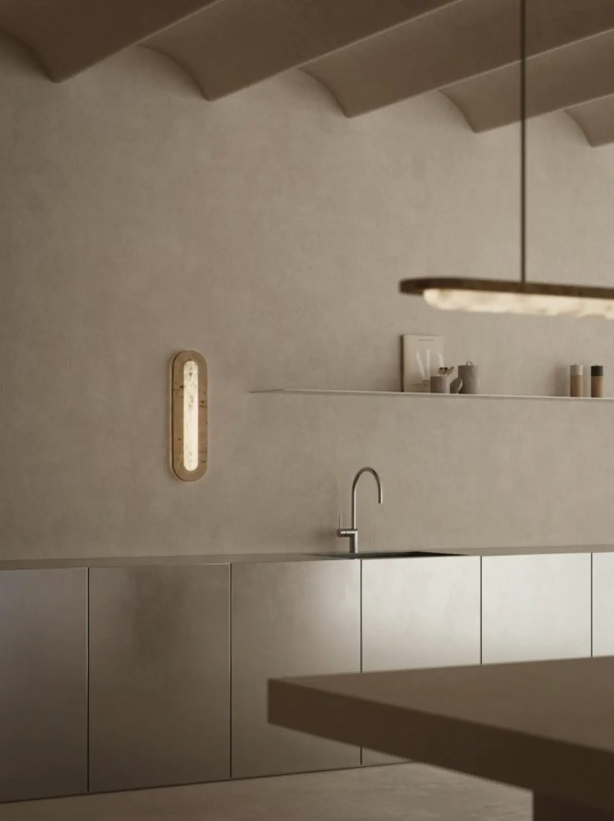 Kitchen with smooth plaster walls and metallic cabinetry, lit by a glowing wall sconce