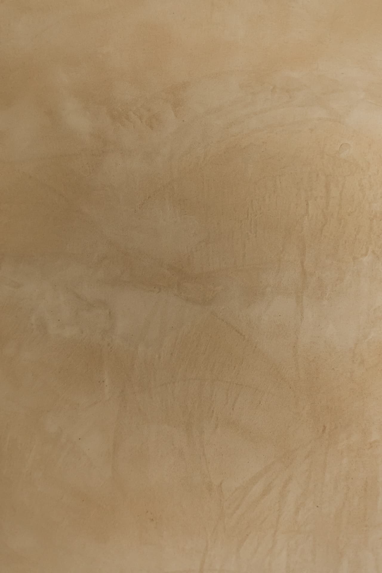 Close-up of hand-troweled microcement texture in tonal warm beige