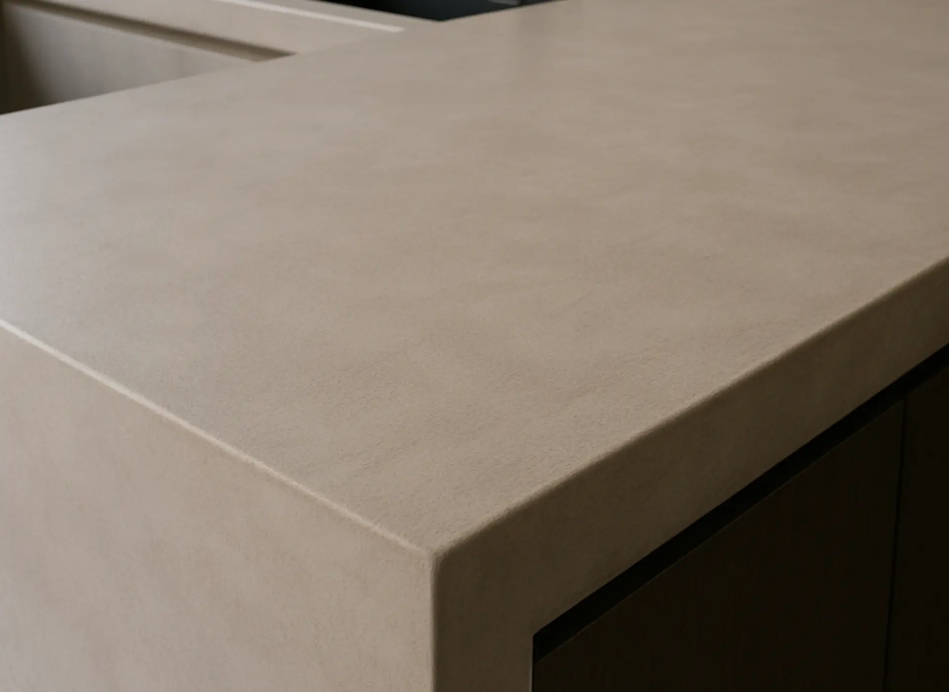 Matte mineral countertop with a waterfall edge in warm taupe